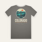 Charcoal tee, back print: a hiker above a turquoise lake and snowy peaks in a circle, COLORADO below