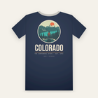 Navy tee, back print: a hiker above a turquoise lake and snowy peaks in a circle, COLORADO below