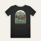 Black tee, back print: a grizzly bear in a wildflower meadow under a snowy peak, inside a large arch
