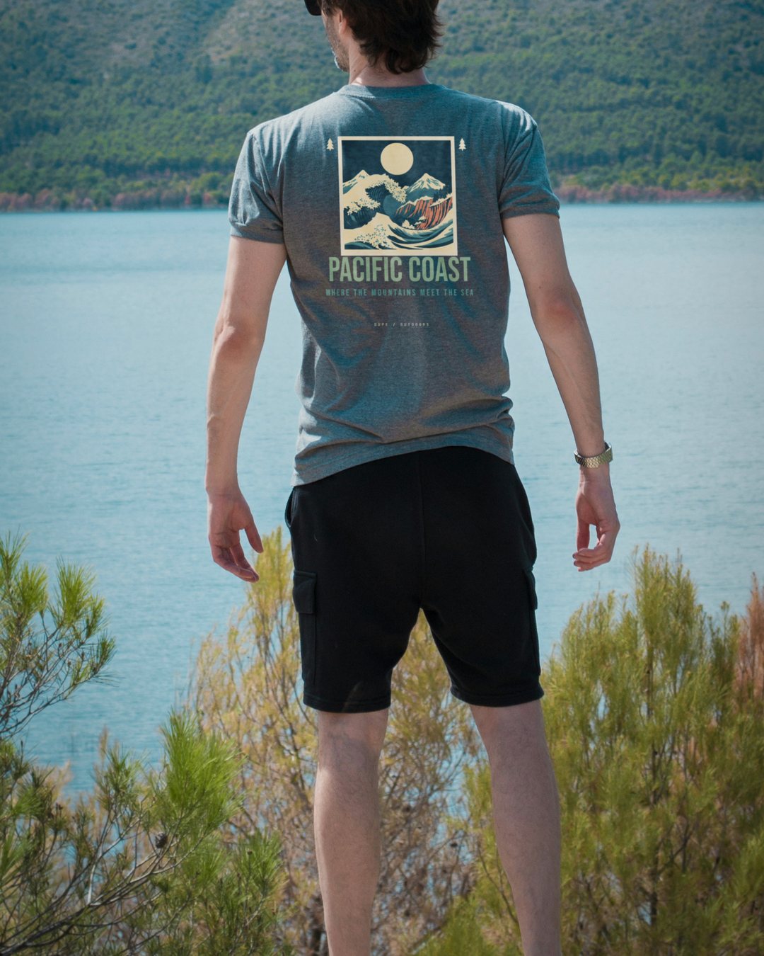 Pacific Coast tee, worn at a lake